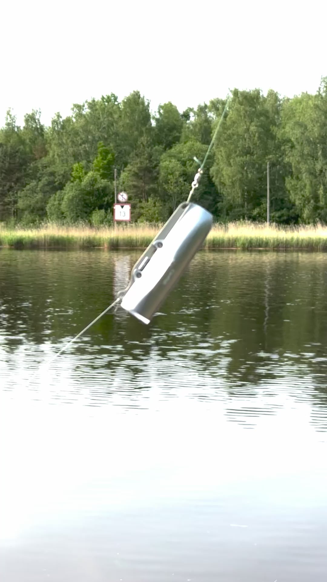 Angler checks the live feed and lure alignment on his underwater fish camera setup